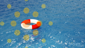 A red and white life preserver floats on the surface of the blue ocean.