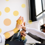 Best Practices for Nonprofit Board Members: Building Financial Resilience That Lasts stock image of a team high five